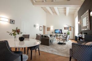 a living room with a table and a couch at Giotto Suite With View in Florence
