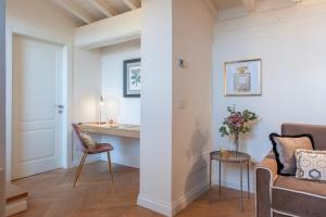 a living room with a couch and a table at Giotto Suite With View in Florence