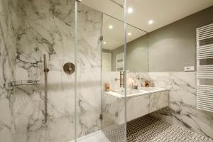 a bathroom with a glass shower and a sink at Giotto Suite With View in Florence