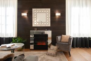 a living room with a fireplace and a chair at Giotto Suite With View in Florence