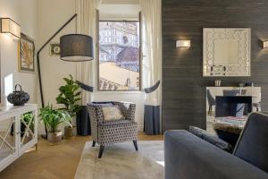 a living room with a chair and a window at Giotto Suite With View in Florence