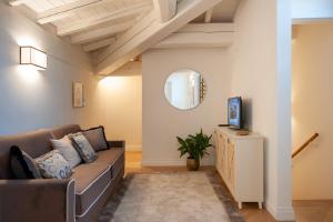 a living room with a couch and a tv at Giotto Suite With View in Florence