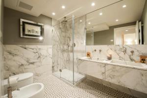 a bathroom with a shower and a toilet and a sink at Giotto Suite With View in Florence +37 photos