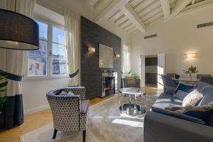 a living room with a couch and chairs and a table at Giotto Suite With View in Florence