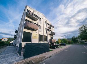 a white building on the side of a street at Main Boardinghouse in Erlenbach am Main