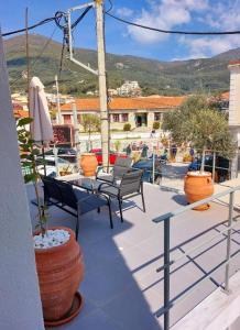 a patio with chairs and a table and a table and chairs at Old Town Studios in Parga