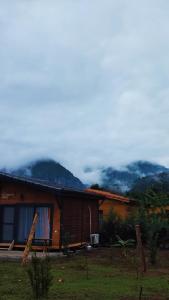 a log cabin with mountains in the background at Chirali Eco Villa in Kemer