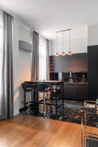 a kitchen with a table and chairs in a room at NEW High-End 2BR Apartment with Parking in Sofia