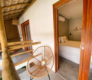 a bedroom with a bed and a fan in a room at Pousada Baobá in Jericoacoara +85 photos