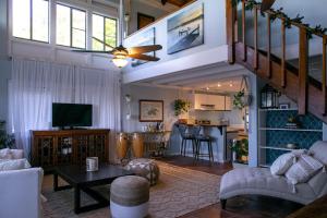 a living room with a couch and a tv at Cruz Bay Tropical Condo in Bethany