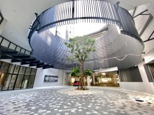 a mall with a tree in the middle of a building at Cozy 1-4Pax SkyTrees AeonBukitIndah NetflixWifi in Johor Bahru
