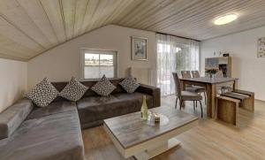 a living room with a couch and a table at Ferienwohnung Staffelberg in Hauzenberg