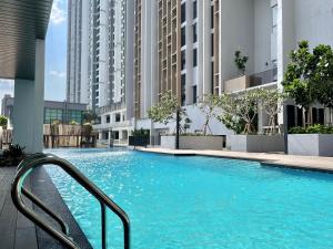 a swimming pool in a building with tall buildings at Cozy 1-4Pax SkyTrees AeonBukitIndah NetflixWifi in Johor Bahru