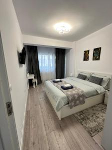a bedroom with a large bed in a room at Angela Nordic apartment. in Suceava