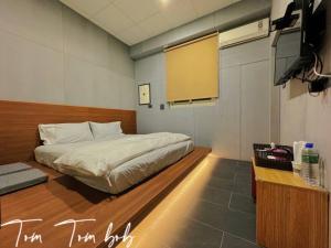 1 dormitorio con 1 cama y TV en 鼓道民宿-步行五分鐘-東大門夜市-及夜市收費停車場, en Hualien City