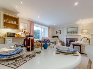 a kitchen and living room with a white table at 2 Bed in Blair Drummond 81513 in Doune