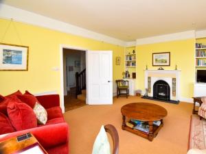 a living room with a red couch and a fireplace at 3 Bed in Brecon Town BN134 in Brecon