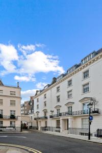 a row of white buildings on a street at Londwell, Sloane Square Gem, Private Terrace Suite in London