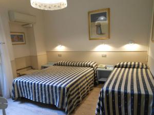 Postel nebo postele na pokoji v ubytování Hotel Stipino