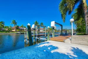 a water park with a water slide and palm trees at VILLA FOUR PALMS - 3 BEDS - 2 BATHS - 6 GUESTS - GULF ACCESS & POOL - INCL.10% OFF BOAT RENTAL in Cape Coral