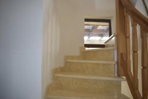 a staircase in a house with a window at Capra cu trei iezi in Sinaia