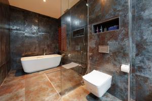 a bathroom with a toilet and a sink and a shower at Yao Bada Badoo Boutique Resort in Ko Yao Yai