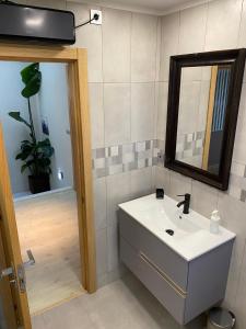 a bathroom with a sink and a mirror at Angeiras Beach House - Porto - Villa by the Sea in Lavra