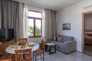 a living room with a table and a couch at Kelaya Luxury Apartments in Gournes
