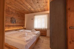 a bedroom with a bed in a wooden room at Casa Alvera Dream in Cortina dʼAmpezzo