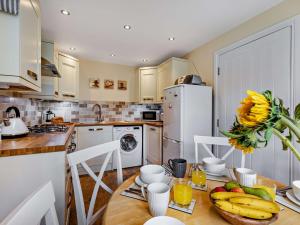 a kitchen with a table with fruit on it at 3 Bed in Watchet 83532 in Watchet