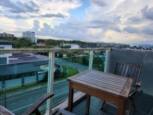 a table and chairs on a balcony with a view at D'Getaway - Kuching Prime Area - Family Oasis - Spacious Condo in Kuching