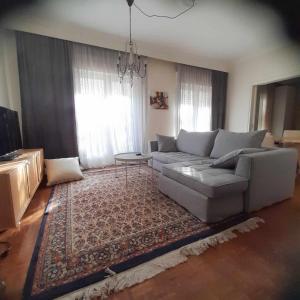 a living room with a couch and a rug at PHILOS Apartment in Old Town Xanthi in Xanthi