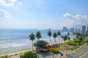 a view of a beach with palm trees and the ocean at Sontra Sea Hotel in Danang