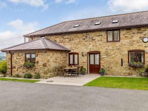 a stone house with a table in front of it at 3 bed in Bagillt 83813 in Bagillt