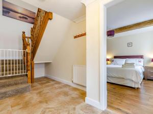 a bedroom with a bed and a staircase in a room at 3 bed in Bagillt 83813 in Bagillt