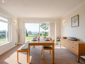 a dining room with a table and a large window at 2 bed in Poole 85399 in Lytchett Matravers