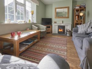 a living room with a table and a fireplace at 3 Bed in Grange in Borrowdale SZ262 in Grange