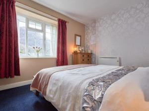 a bedroom with a large bed and a window at 3 Bed in Grange in Borrowdale SZ262 in Grange