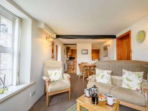 a living room with a couch and chairs and a table at 1 bed in Eskdale SZ503 in Beckfoot