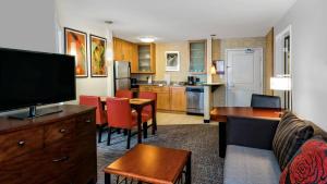 a living room with a couch and a kitchen at Residence Inn by Marriott San Antonio SeaWorld / Lackland in San Antonio