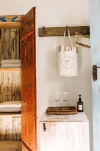 a room with a table with a white bag and glasses at Casa La Torre Hotel Boutique in Trancoso