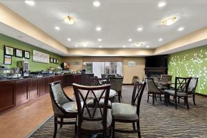 a waiting area at a restaurant with chairs and a counter at Sleep Inn & Suites near Joint Base Andrews-Washington Area in Morningside