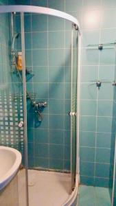 a shower with a glass door in a bathroom at Heart of Old Town studio with self check in in Bucharest
