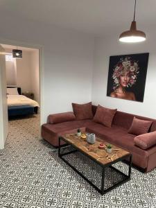a living room with a couch and a coffee table at Family Apartment With Private Yard Next to Agios Dimitrios Church in Thessaloniki