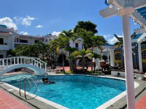 a person swimming in the pool at a resort at Villa Apolonia Resort in San Juan
