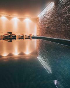 a room with a swimming pool with toilets in it at Astoria Resort in Riva del Garda
