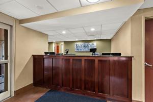 an office with a large wooden reception desk at Sleep Inn & Suites near Joint Base Andrews-Washington Area in Morningside