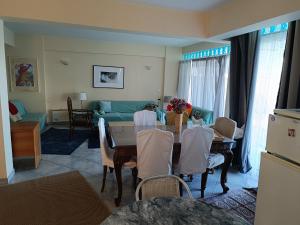 a living room with a table and a couch at Mare e Monti1 in Kamena Vourla