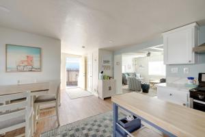 a kitchen and living room with white cabinets and a table at Pet-Friendly Cayucos Home Walk to Public Beach! in Cayucos