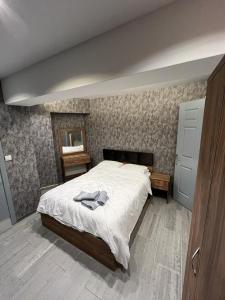 a bedroom with a bed with a white comforter at GRAND LOFT OTEL in Bursa